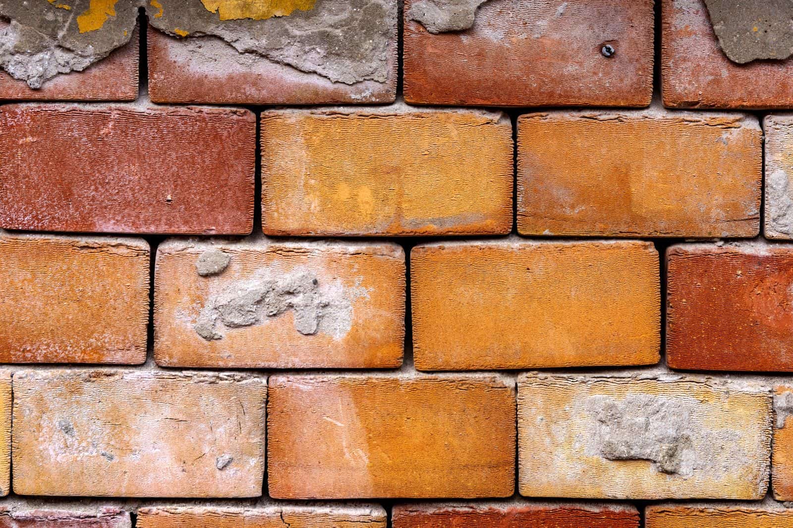 Close-up of aged red brick with weathered mortar joints