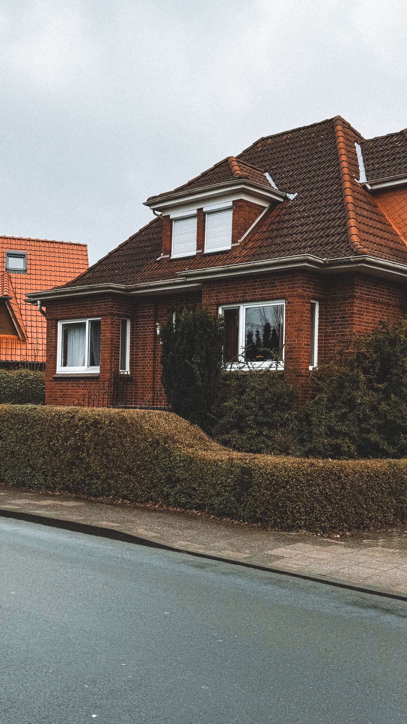 A suburban brick home with a chimney on the side wall
