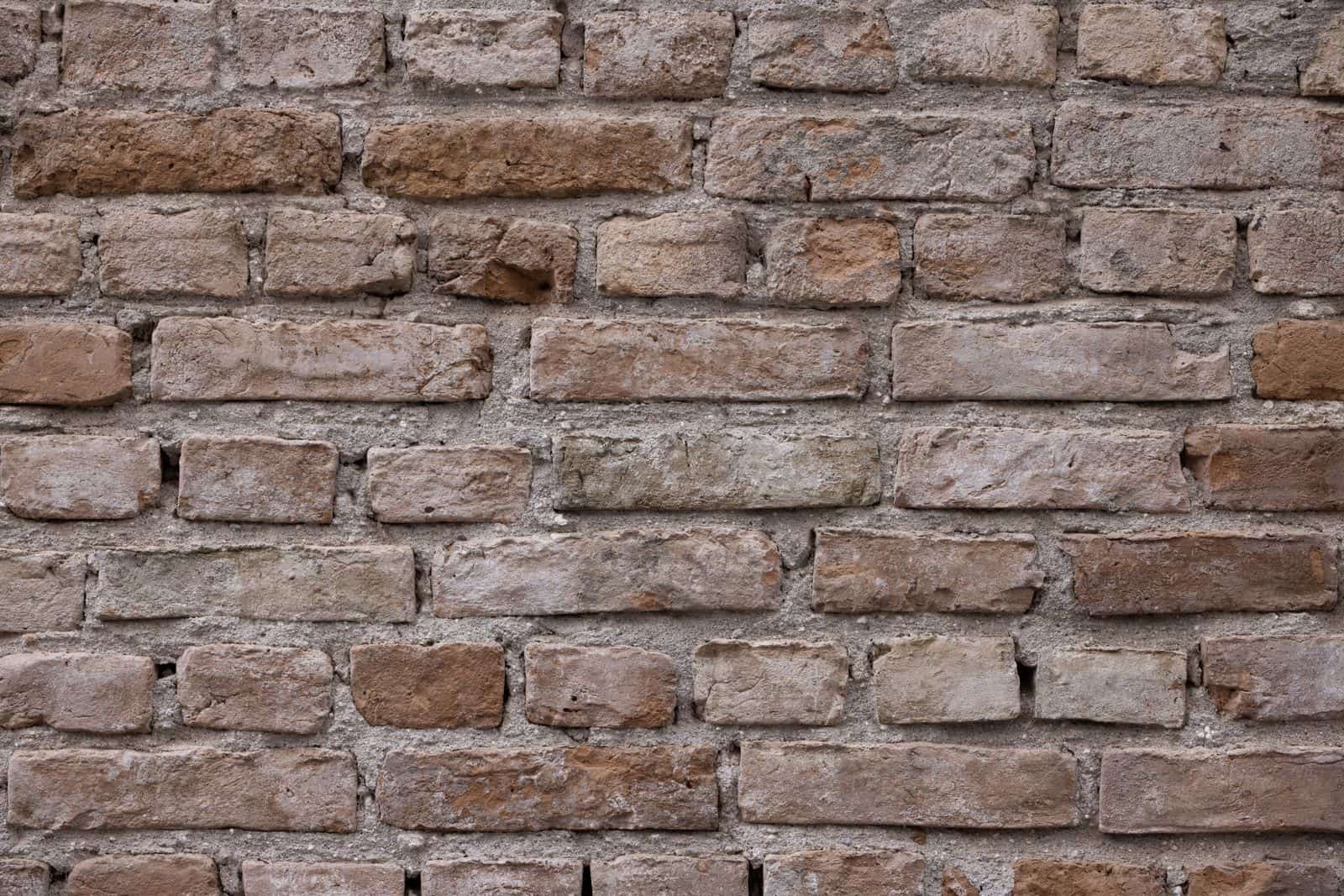 Weathered brick with worn, receding mortar joints