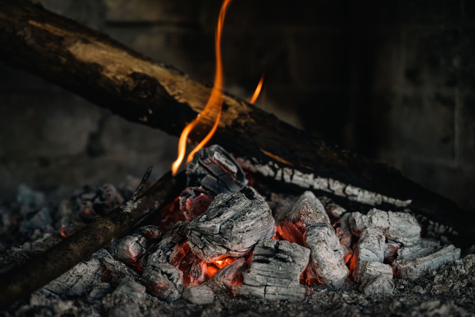 An outdoor fire pit with an open fire burning