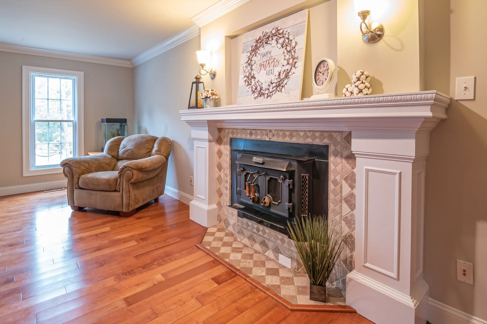An armchair beside a lit fireplace