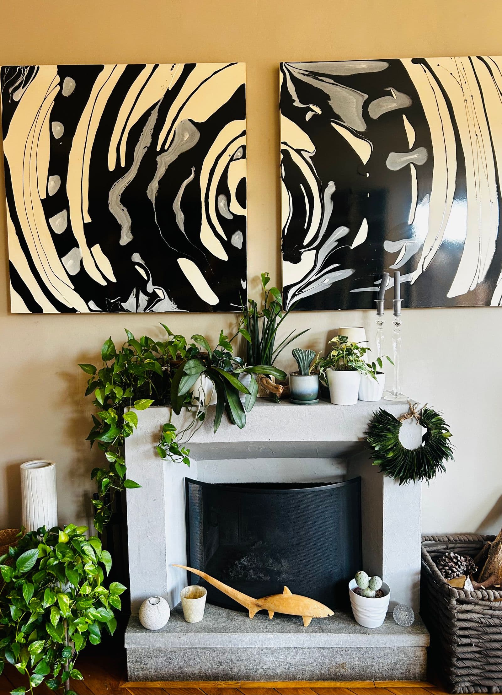 A modern fireplace with artwork above the mantel