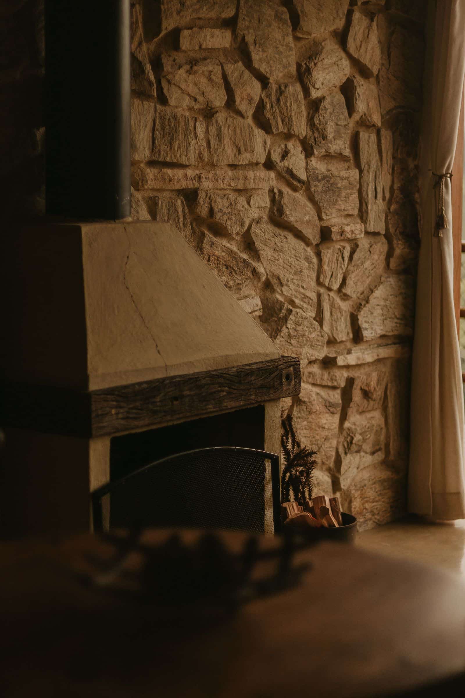 A stone hearth beneath a fireplace opening